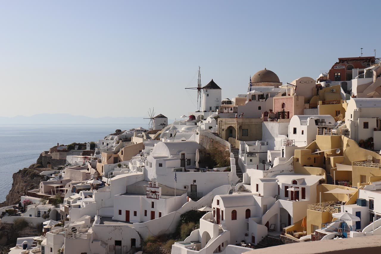 White-washed buildings of Santorini overlooking the Aegean Sea — connect across Greek islands with an LTE.app eSIM